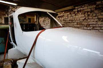 Repair and painting of an old small plane. of the old airfield. Wings. Airport.