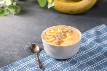 Healthy pineapple, mango smoothie bowl with banana and almond