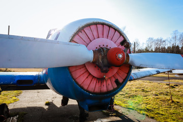 A small plane stands in the parking lot of an old airfield. Wings. Airport. Airfield. Flights by plane.