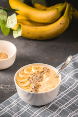 Healthy pineapple, mango smoothie bowl with banana and almond