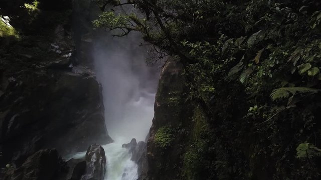 Flying between trees to reveal the waterfall, Pylon del Diablo in Banos de Ambato Ecuador. Dynamic drone shot.