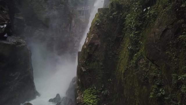 Dynamic shot of the Devil's pylon waterfall in Banos de Ambato Ecuador.  Drone reveals waterfall in beautiful location.