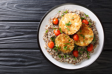 Vegan food baked eggplant served with boiled quinoa close-up on a plate. Horizontal top view