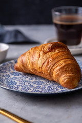 Breakfast with croissant and black coffee