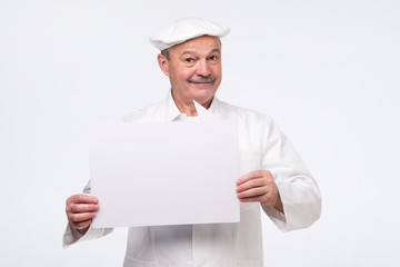 Senior cook man holding sign speech bubble smiling delighted. Isolated on white background.