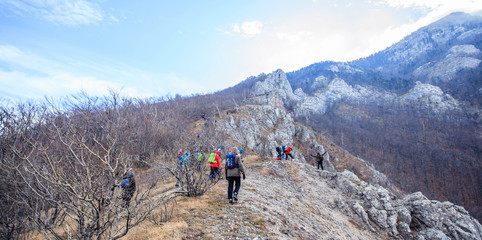 Fototapeta premium People trekking on the winter mountain landscape