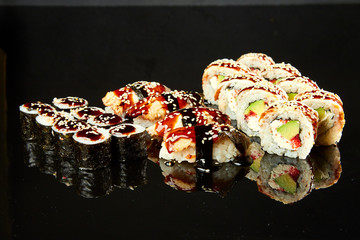 Various kinds of sushi roll set served on black stone. Japanese food