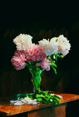 bouquet of flowers in vase on black background