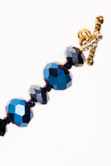 bead decoration. necklace and bracelet. blue beads. clasp on the decoration. a grid of beads....