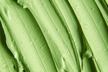 Green cosmetic clay (cucumber facial mask, avocado face cream, green tea body wrap) texture close...