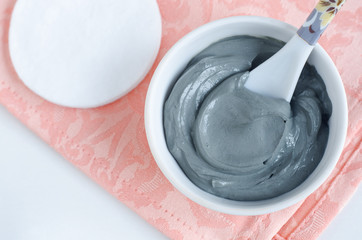 Blue bentonite clay in a bowl. Diy facial mask and body wrap recipe. Natural beauty treatment and...