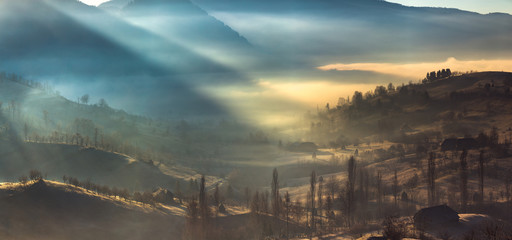 Beautiful misty village rural landscape at sunrise in Romania