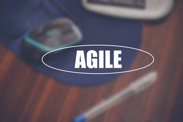 Agile word with business blurring background