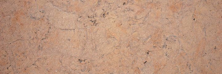 Brown sandstone wall texture. Close-up panoramic photo of brown background