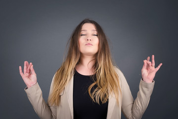 Meditation, religion and spiritual practices. Beautiful young blond haired female doing yoga in the...