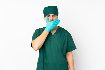 Fototapeta na wymiar Surgeon in green uniform isolated on isolated white background covering mouth with hands