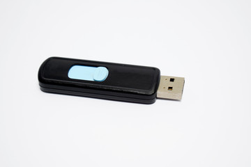 Blue and black colored pen drive placed on a white isolated background