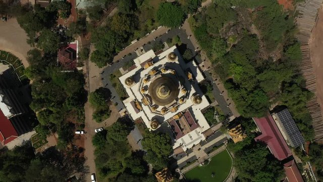 Top down rotating Aerial view of Buu Long Pagoda, a beautiful Buddhist temple with large gold roof structure in Saigon, Ho Chi Minh City, Vietnam on a sunny clear day