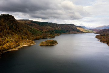 Stunning aerial drone landscape image of glorious vibrant Autumn Fall sun over Thirlmere in Lake District