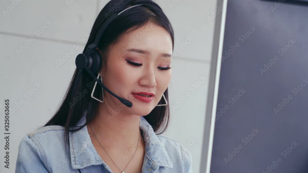 Aufkleber customer support agent or call center with headset works on desktop computer while supporting the cu