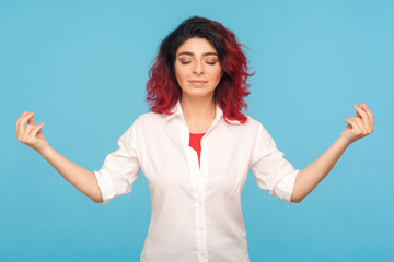 Relaxation and harmony. Portrait of peaceful hipster woman with fancy red hair keeping hands in...