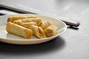 Spring rolls on a white plate. 