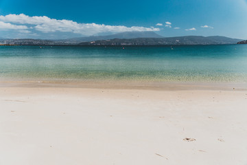 landscape in Opossum Bay Beach on a sunny summer day with nobody on the beach with deep blue water...