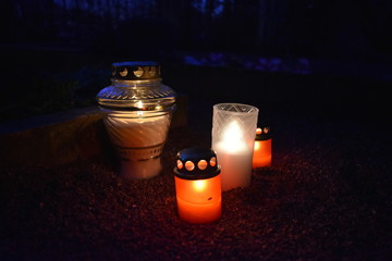 Dark glowing cemetery candle lights