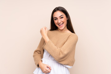 Obraz premium Young caucasian woman isolated on beige background celebrating a victory