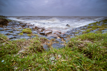Storm on the Dutch coast with breaking waves on the shore