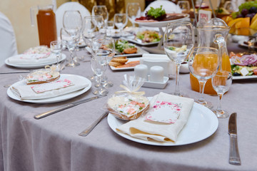 Table setting with sparkling wineglasses and cutlery on table, copy space. Menu mockup, place setting at wedding reception. Table served for wedding banquet in restaurant