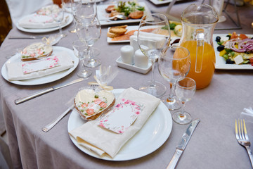 Table setting with sparkling wineglasses and cutlery on table, copy space. Menu mockup, place setting at wedding reception. Table served for wedding banquet in restaurant