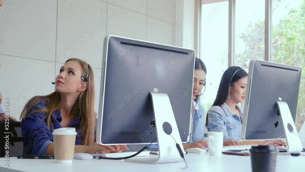 Aufkleber customer support agent or call center with headset works on desktop computer while supporting the cu