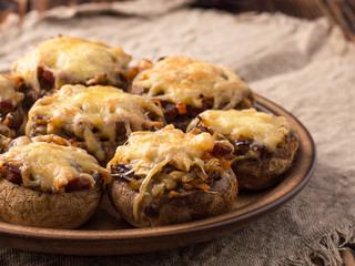 Baked mushrooms in the oven with cheese and vegetables.