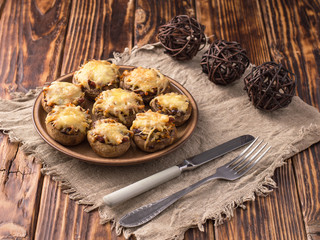 Baked mushrooms in the oven with cheese and vegetables.
