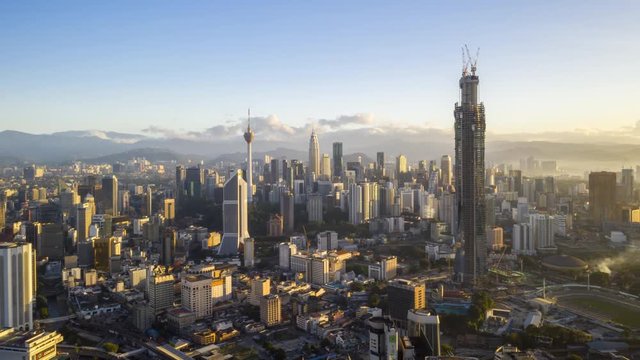 Kuala Lumpur, Malaysia - January 5, 2020: 4k establishing b-roll cinematic shot of hyperlapse drone panning view of sunrise at Kuala Lumpur city skyline. 