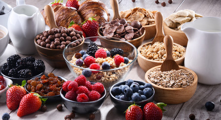 Different sorts of breakfast cereal products and fresh fruits
