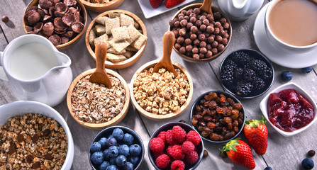 Different sorts of breakfast cereal products and fresh fruits