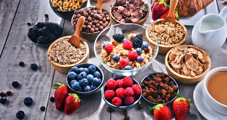 Different sorts of breakfast cereal products and fresh fruits