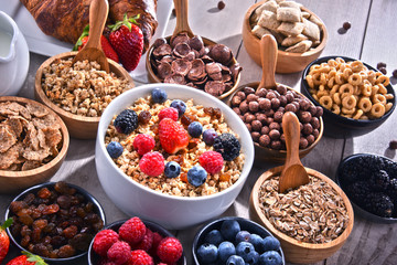 Different sorts of breakfast cereal products and fresh fruits