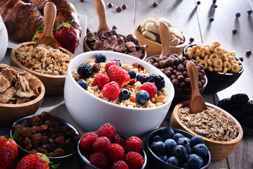 Different sorts of breakfast cereal products and fresh fruits