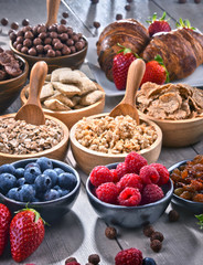 Different sorts of breakfast cereal products and fresh fruits