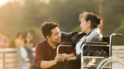Portrait of Asian senior mother and young man son smile and happy face - 325073882