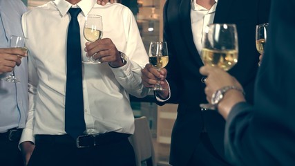 Successful business people drink wine and champagne with team members in ball room to celebrate business project to launch new product to market. Corporate business and people networking concept.