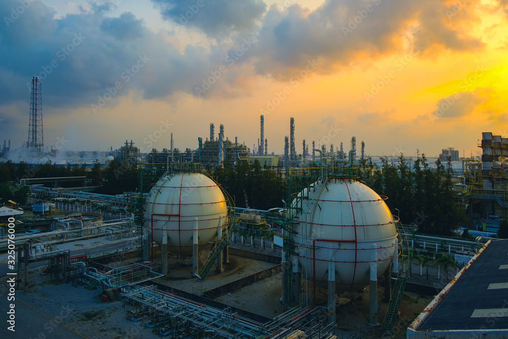 Wall mural gas storage sphere tanks and pipeline in oil and gas refinery industrial plant on sky sunset backgro