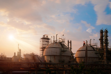 Gas storage sphere tank in Oil and gas refinery plant with sunset sky background