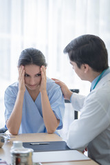 A doctor takes care of a sick patient woman with sadness and unhappiness at the hospital or medical clinic.