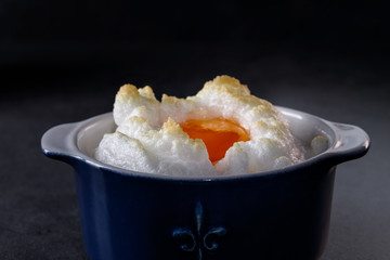Delicate baked egg Orsini (eggs in the cloud). French breakfast.