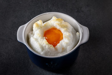 Delicate baked egg Orsini (eggs in the cloud). French breakfast.