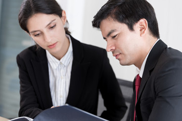 A manager and secretary working together in the office.